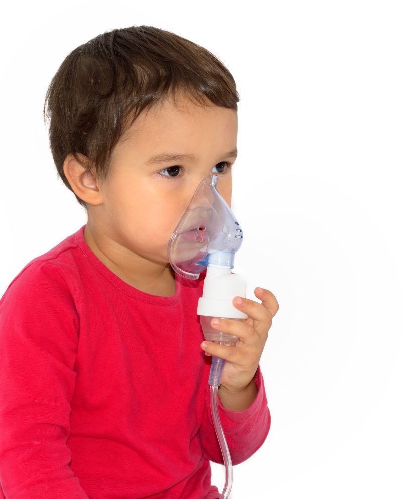 Young boy using a nebulizer.
