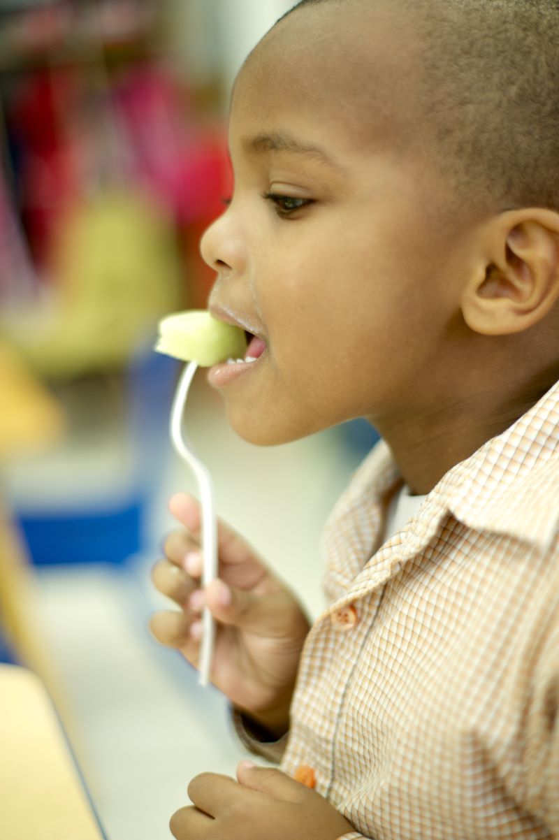 Child eating healthy foods.
