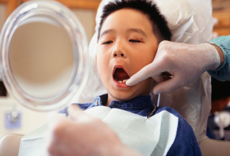 Child having their teeth examined by the dentist.