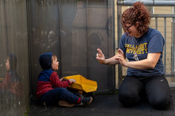 Adult using ASL with a child.