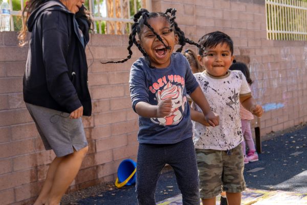 Several happy children playing outdoors.