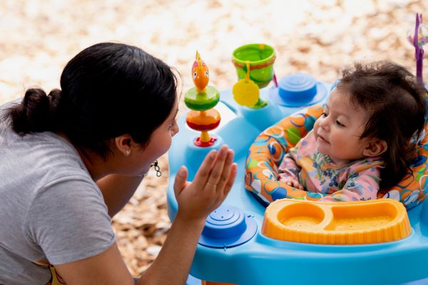 Teacher clapping with baby.