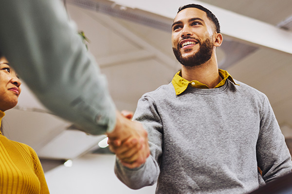 Man shaking another person's hand.